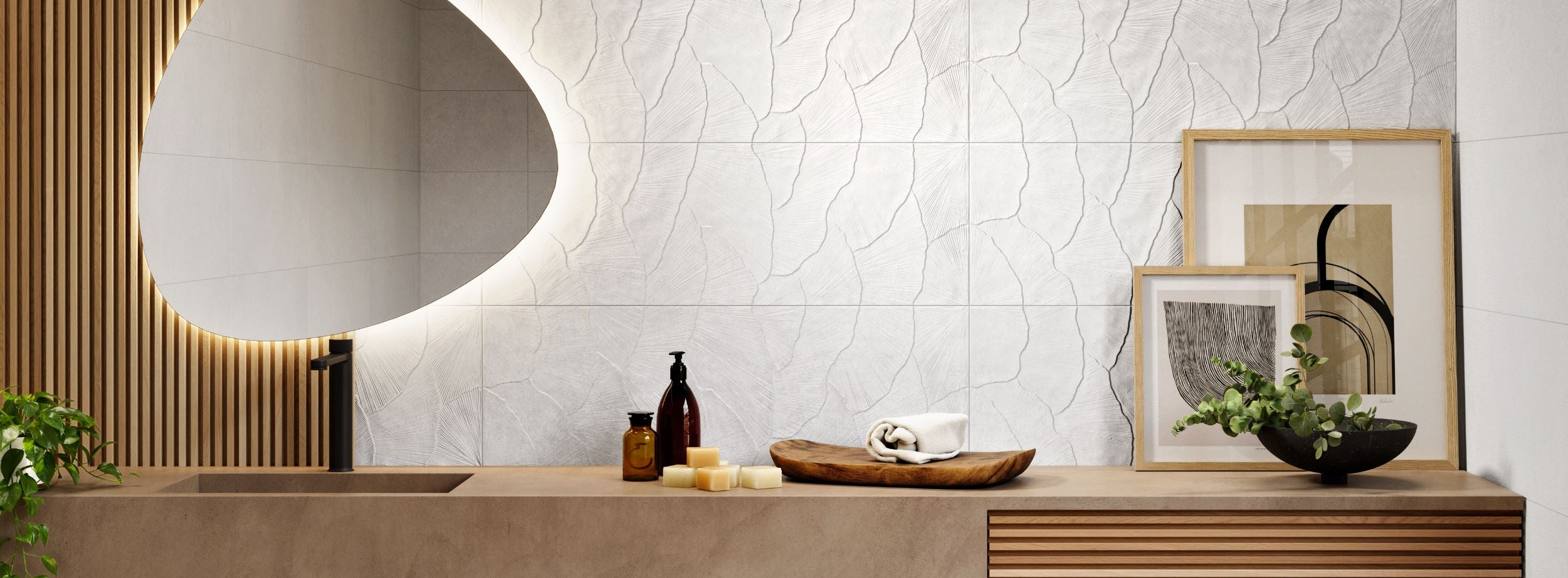 Modern bathroom interior with a sink, White decorative tiled wall, and framed art on a wooden shelf.