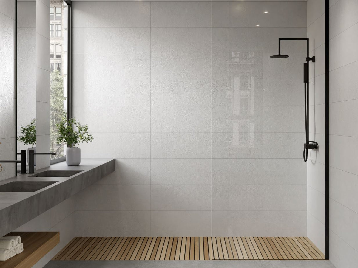 Modern bathroom with a white tiled walls, a shower, and a window.